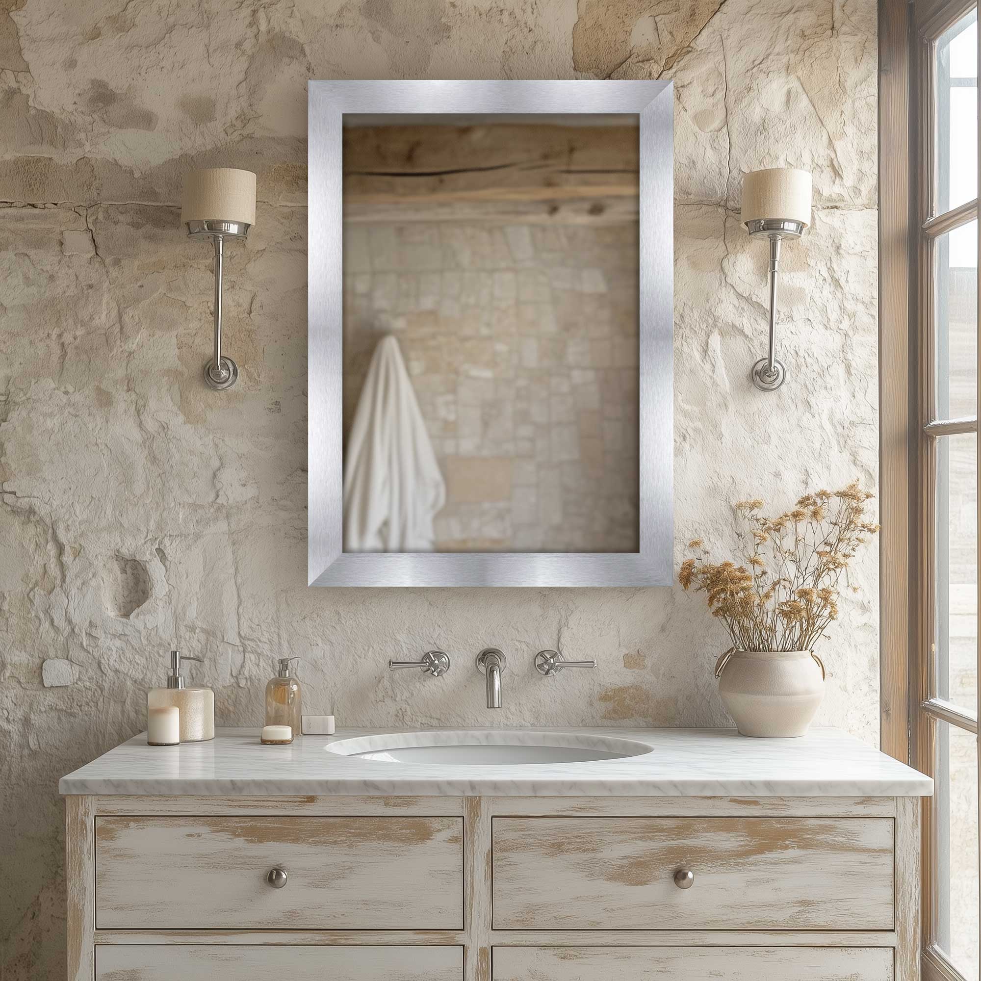 silver contemporary wall mirror between two lamps
