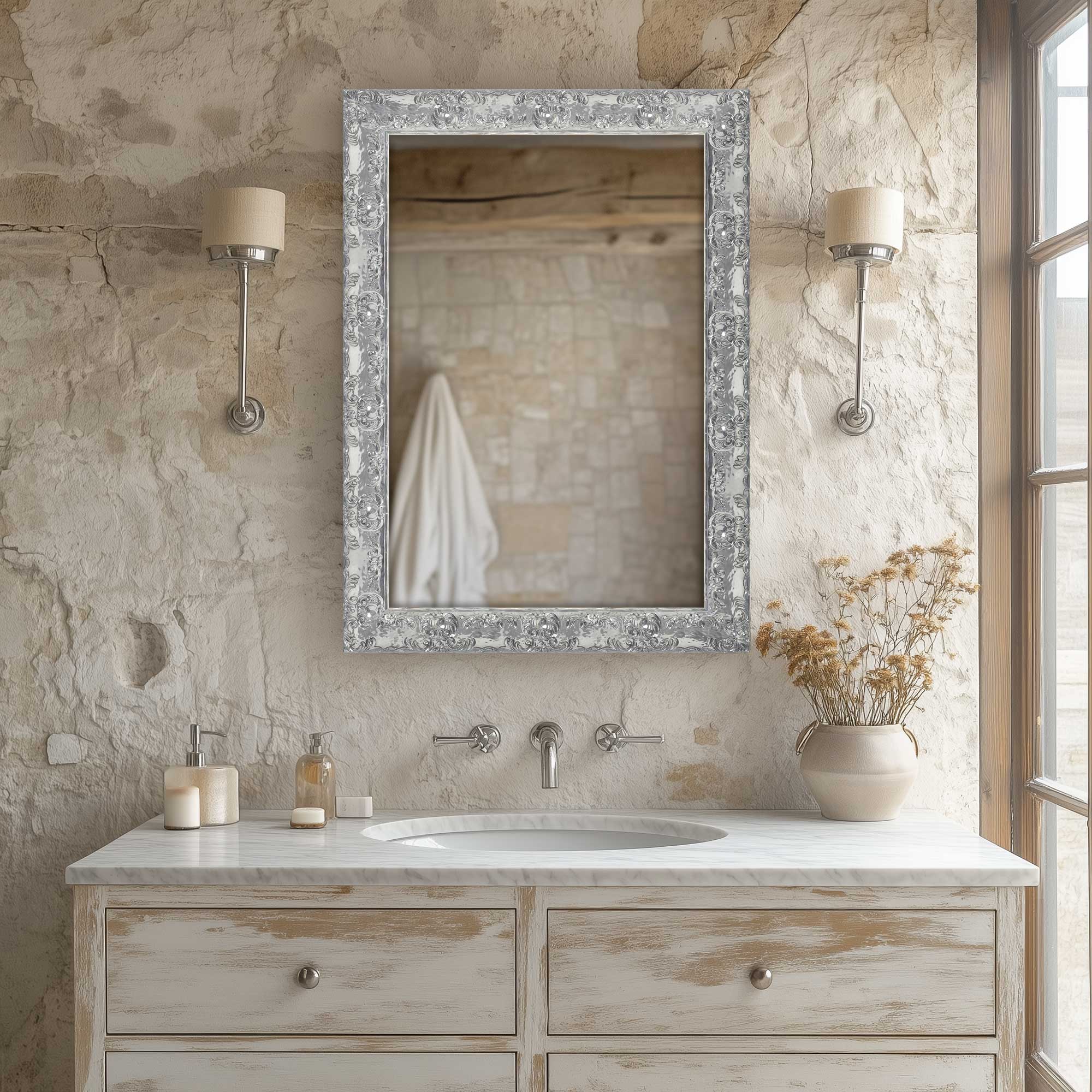 electric silver regal ornate wall mirror hanging above bathroom sink