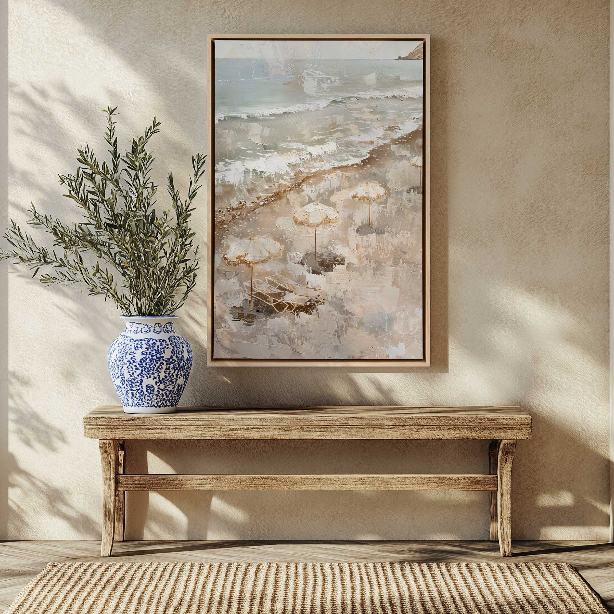 seaside umbrella calm IV print on canvas in a maple floater frame hanging above a bench and some dried ferns