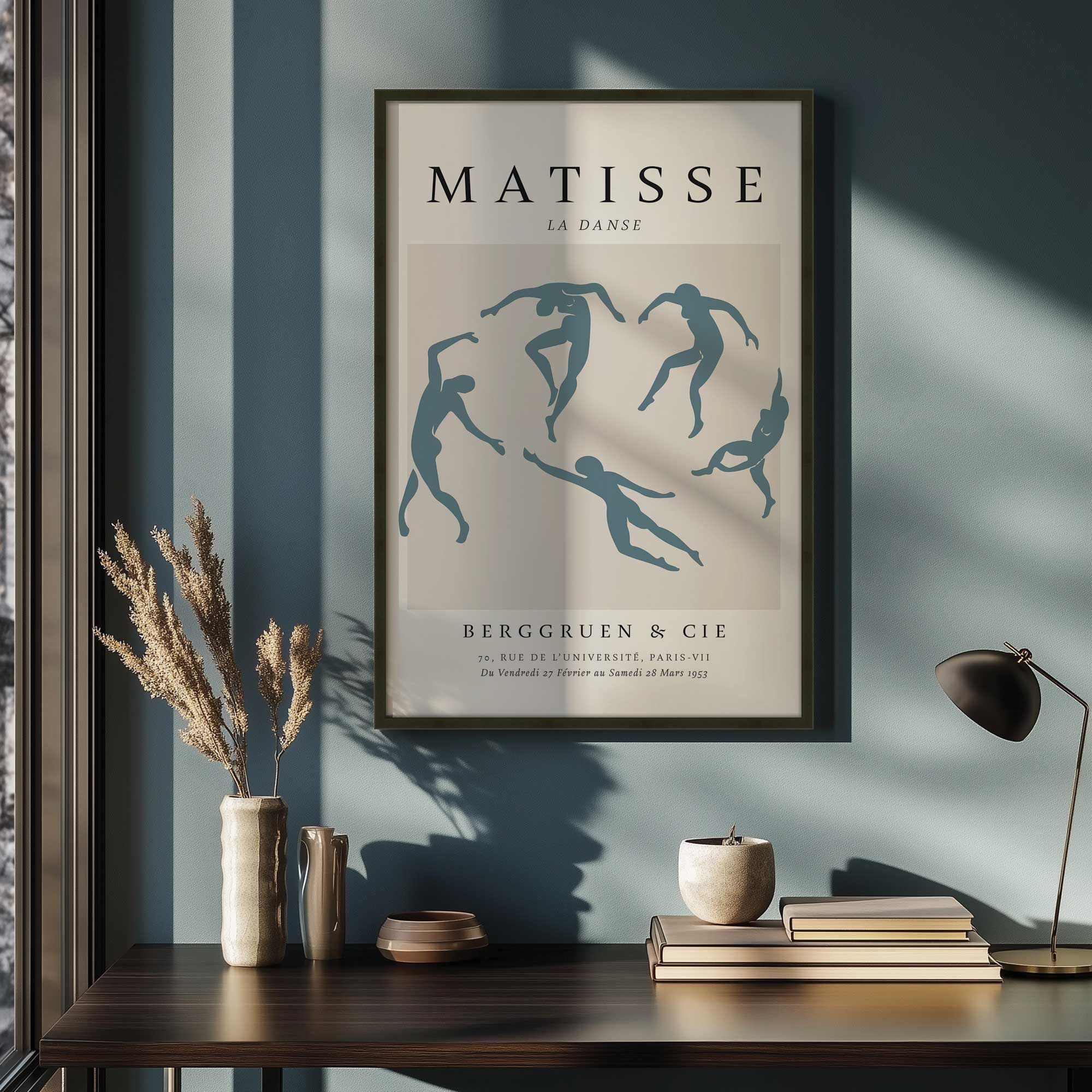 Matisse's La Danse in Midnight blue print in a black frame hanging above desk