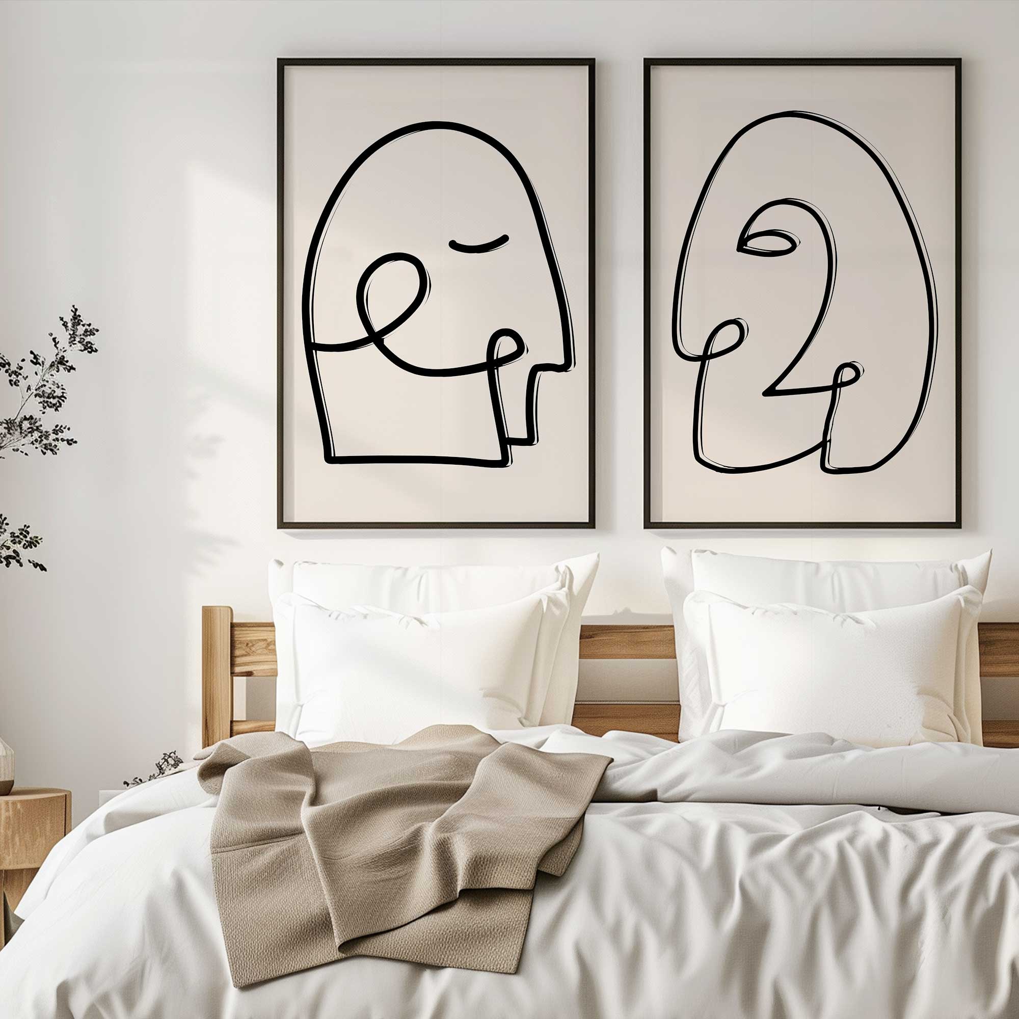 mindful gaze set of 2 prints framed in black frames hanging over a bed