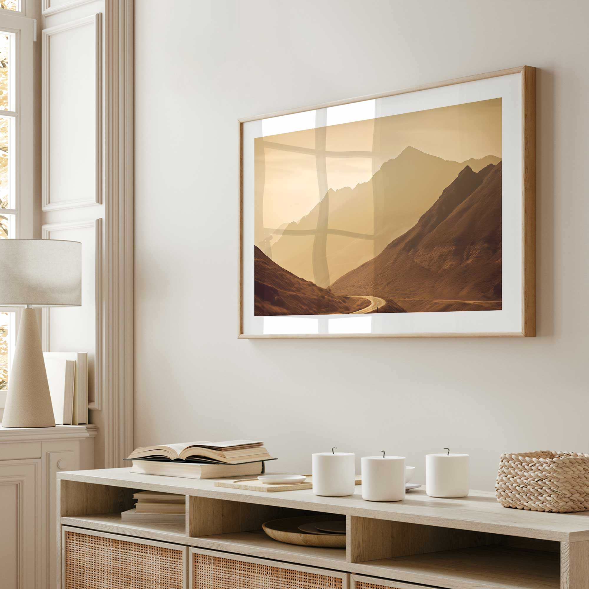Peaceful mountain drive II framed photograph print hanging above a console table