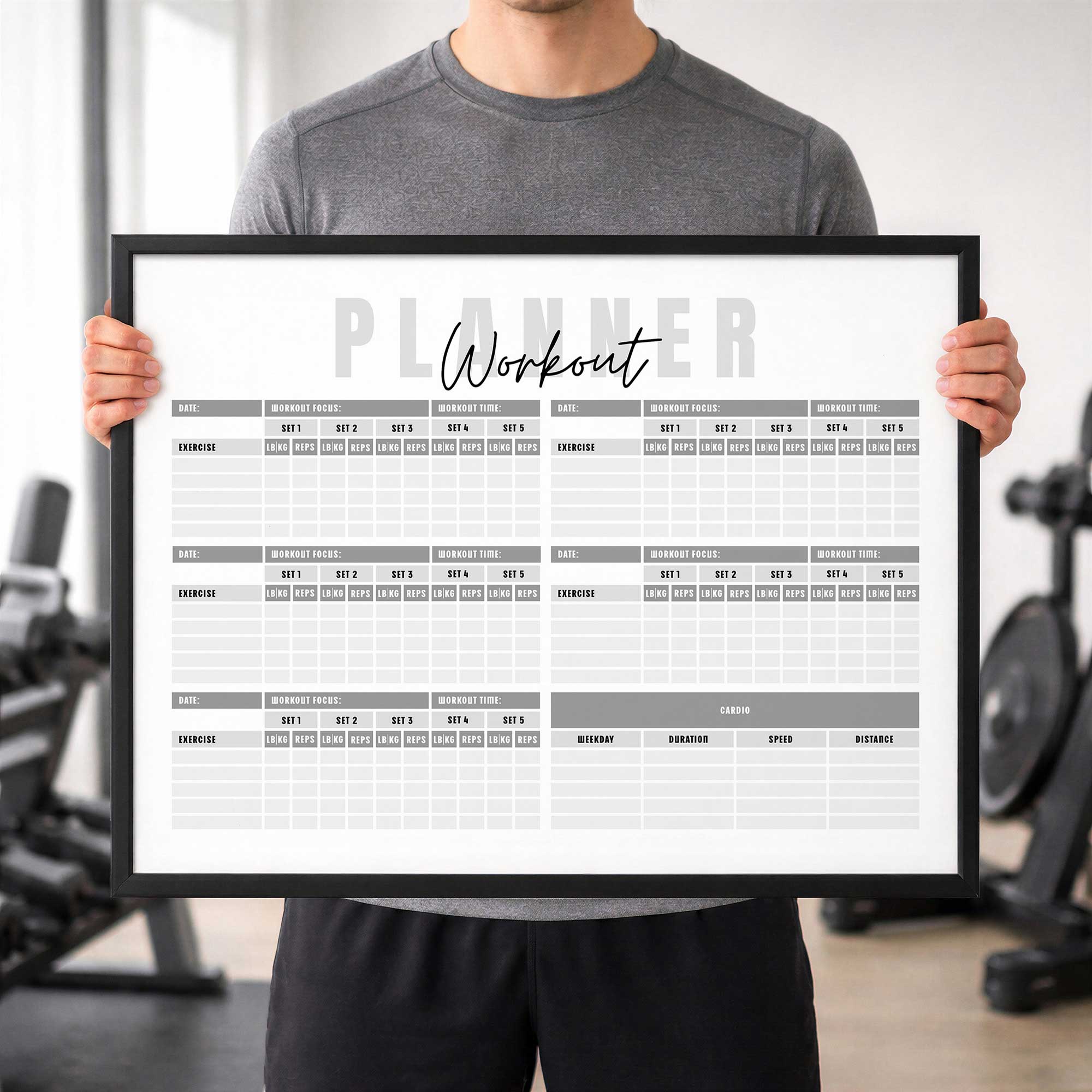 man holding a dry erase workout planner at the gym