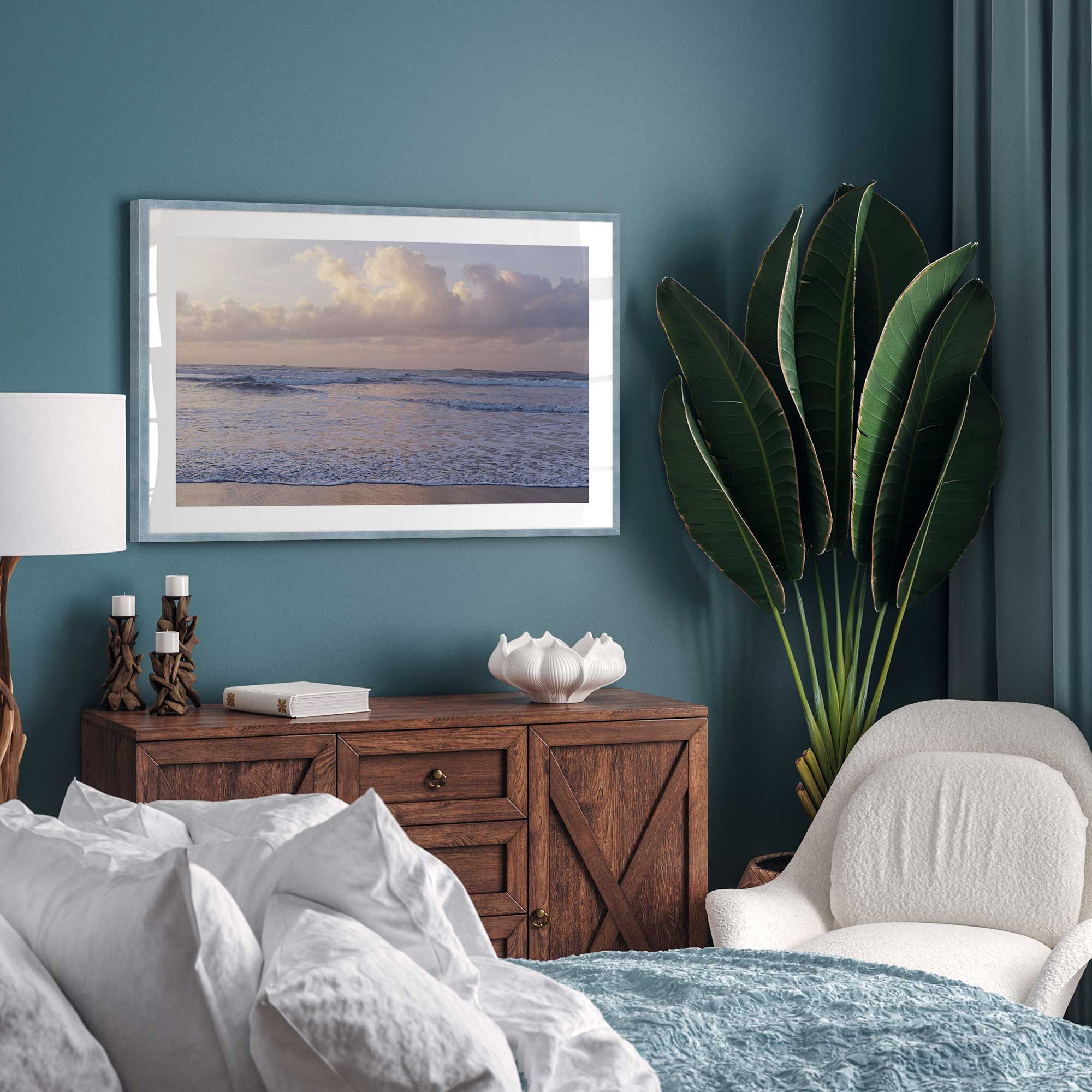 normandy's dusk dream beach print in a blue frame in a traditional bedroom