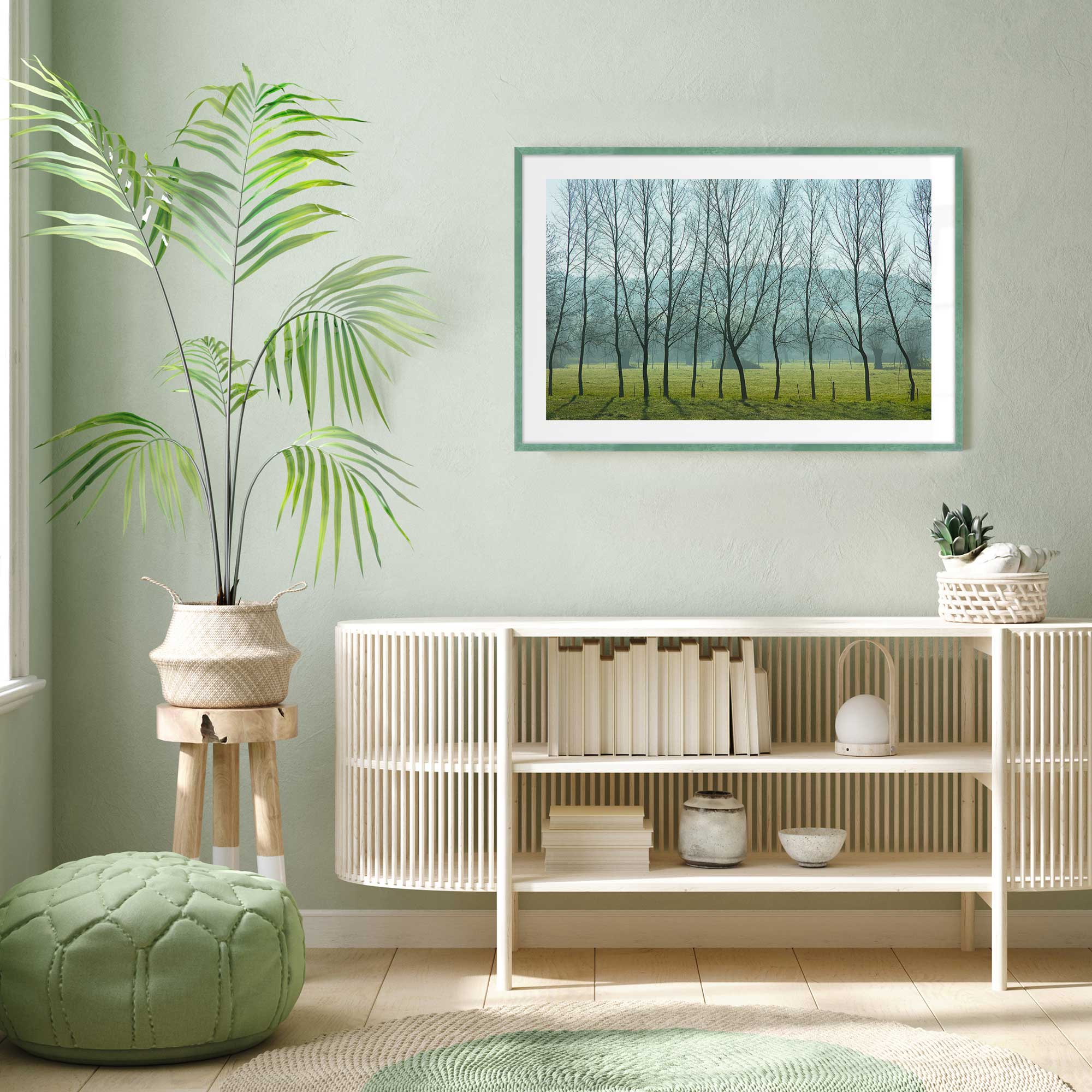 misty normandy meadow print in a green frame on the living room wall