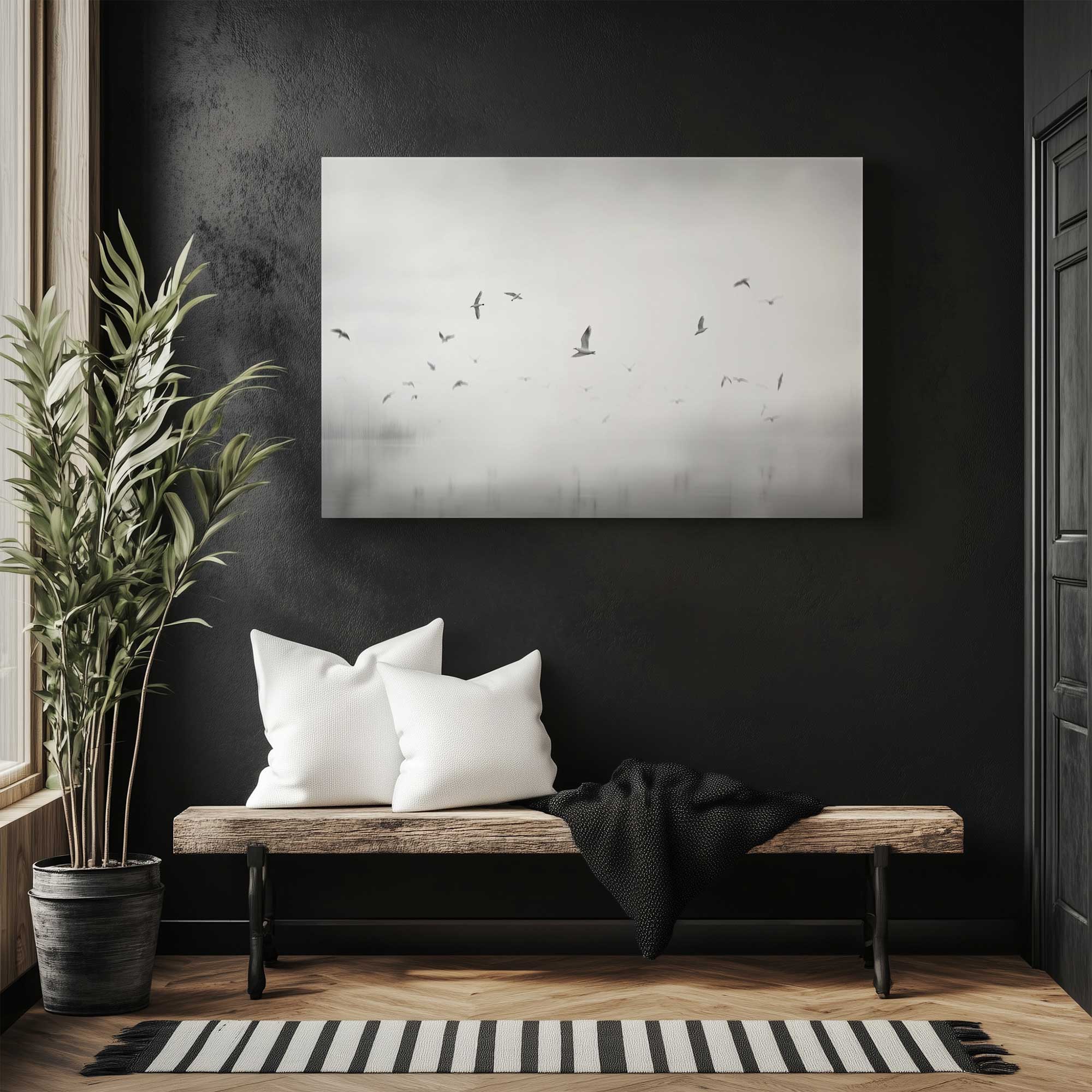 black and white photograph of flying birds above a lake hanging in a minimalist entryway