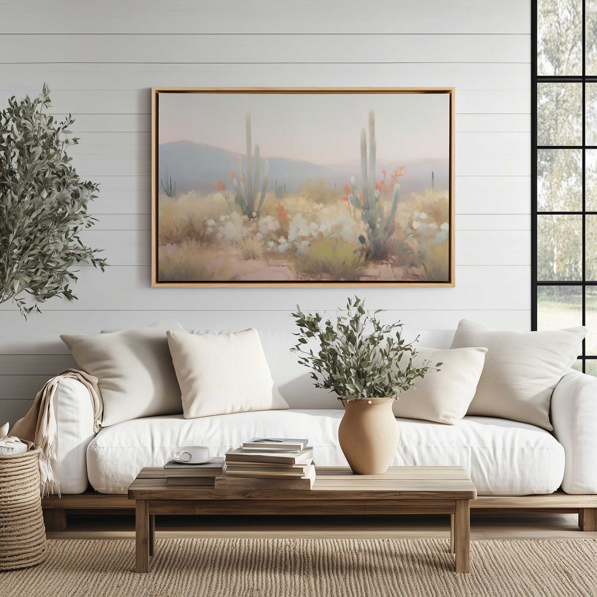 Twilight Cacti print of dreamy desert landscape on framed canvas hanging above a couch