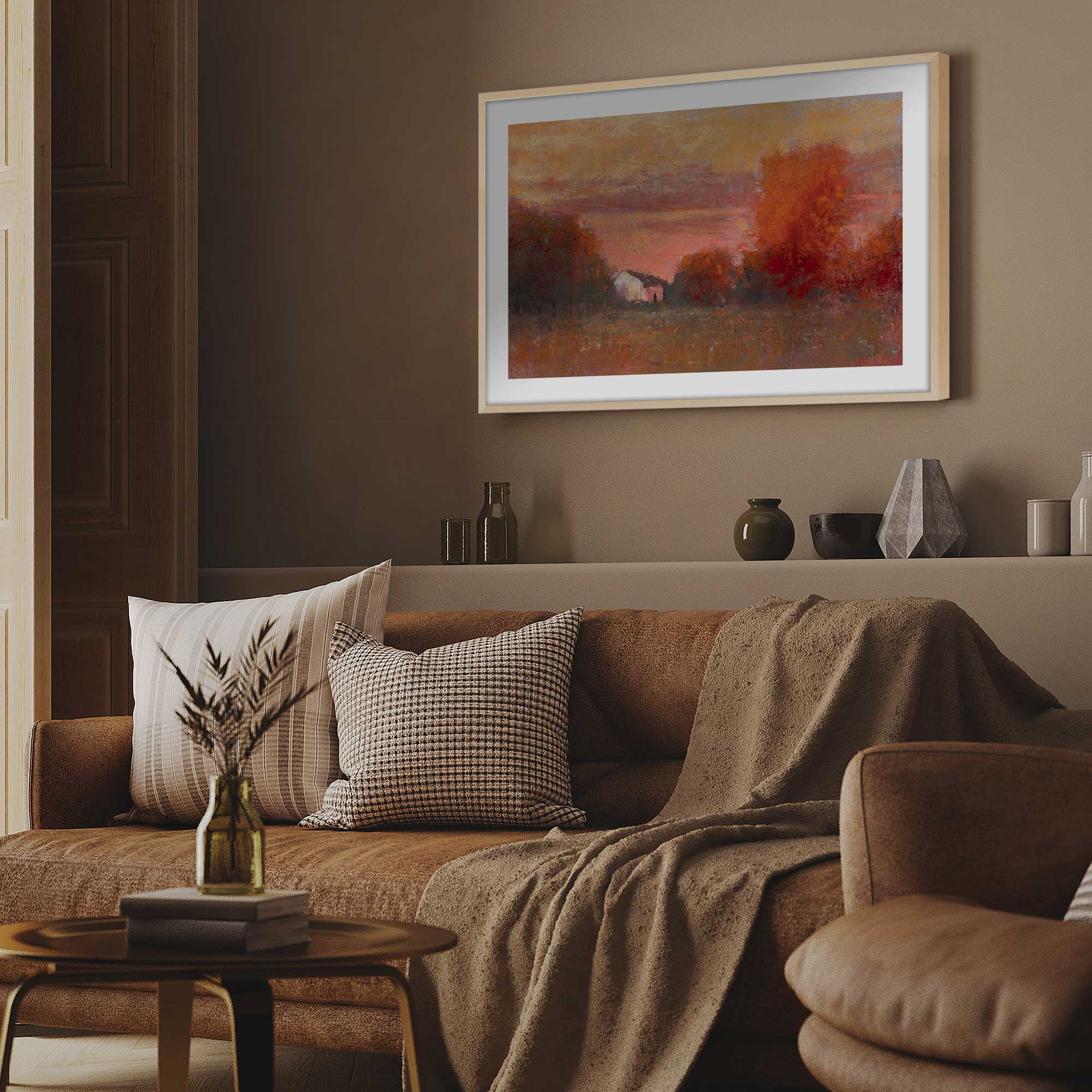 tangerine skies print in a wood frame above a couch