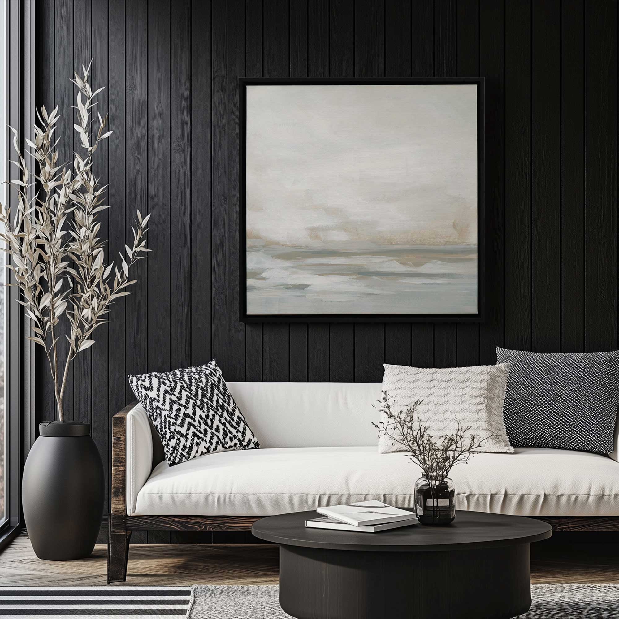 winter seascape serenity II print on canvas hanging above a couch in a modern black and white living room