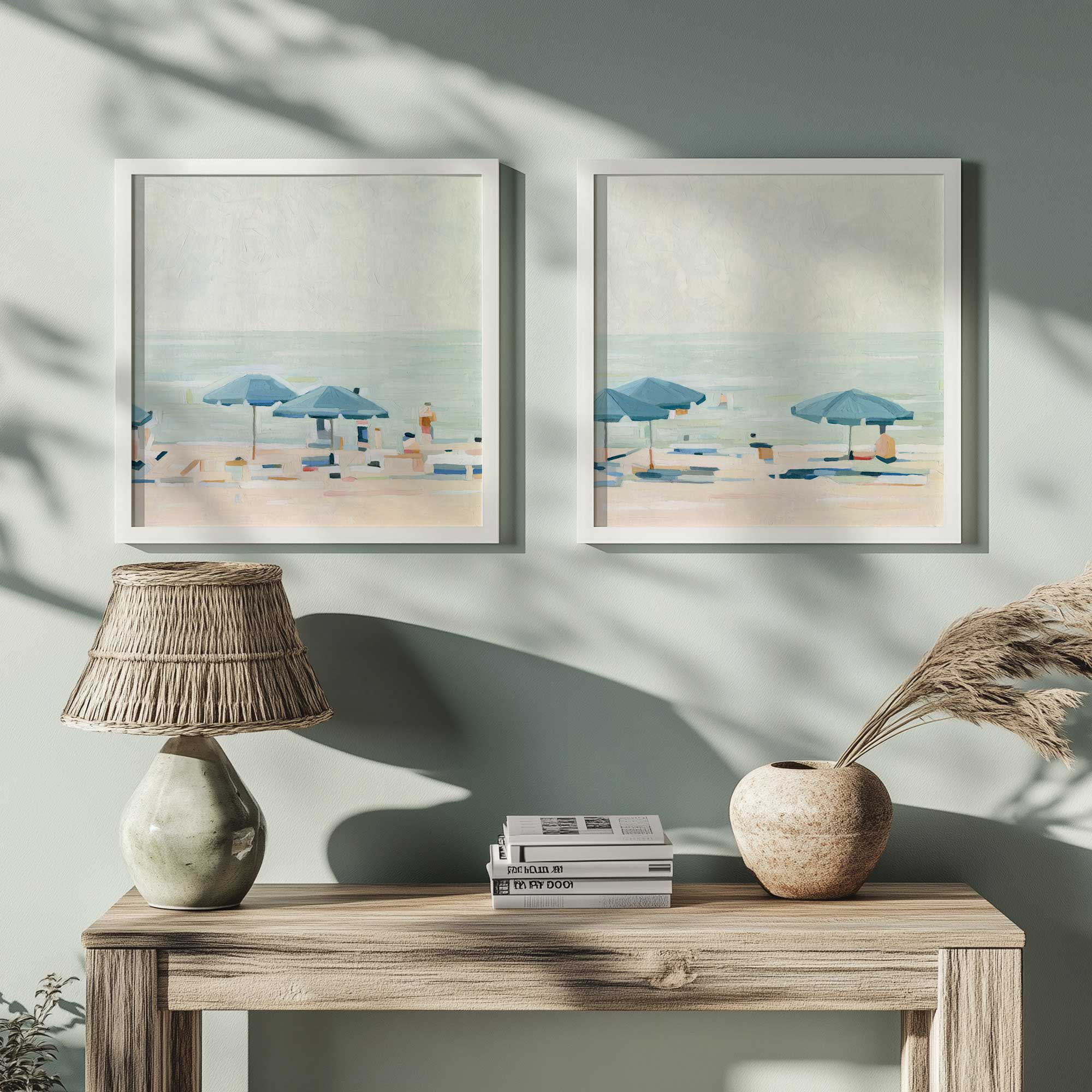 seaside umbrella harmony set of 2 framed prints hanging above a console table with a sage lamp and some pampas grass