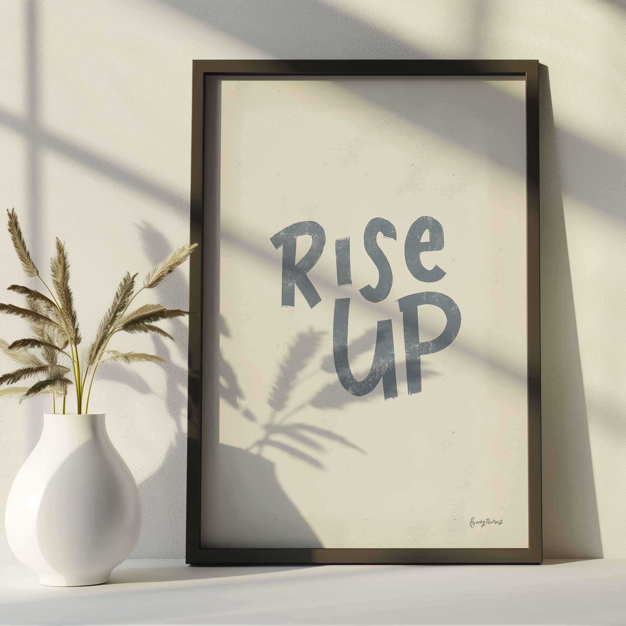 rise up motivational art print on a desk