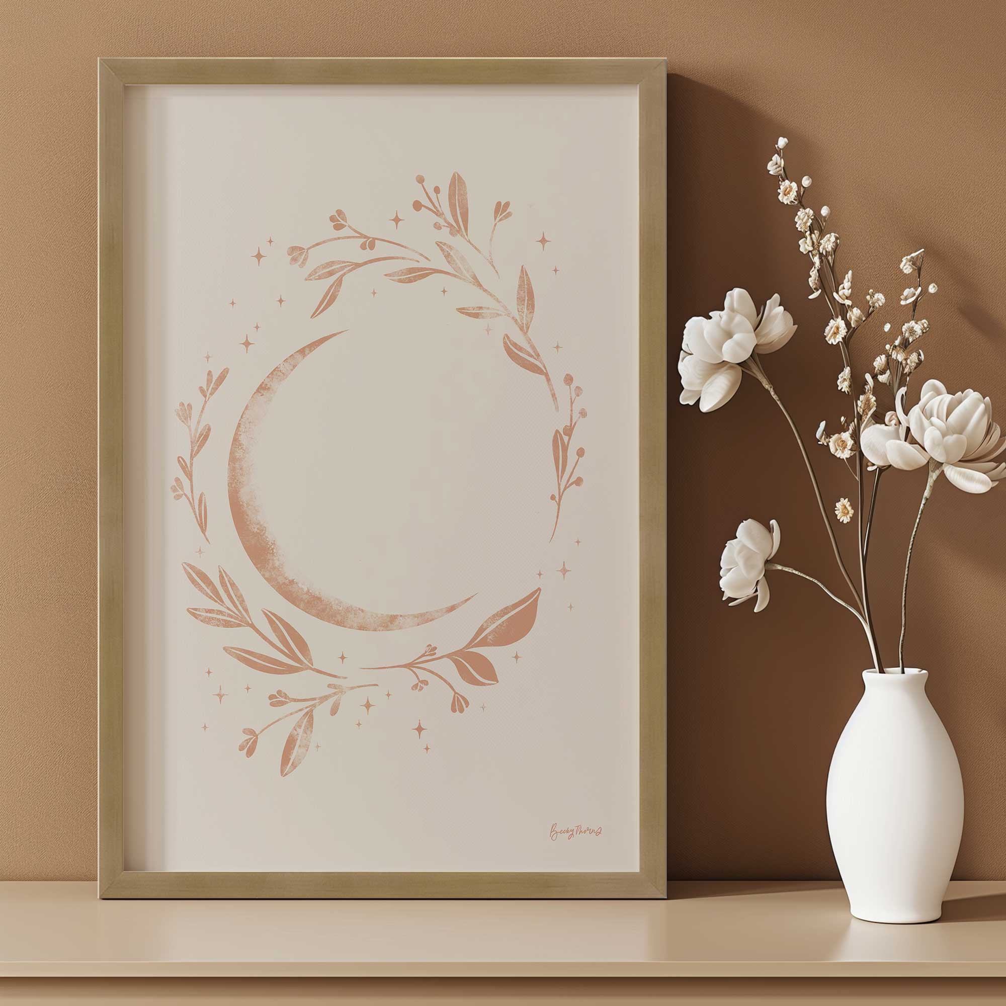 Lunar blossom framed art print in a gold frame leaning on a console table