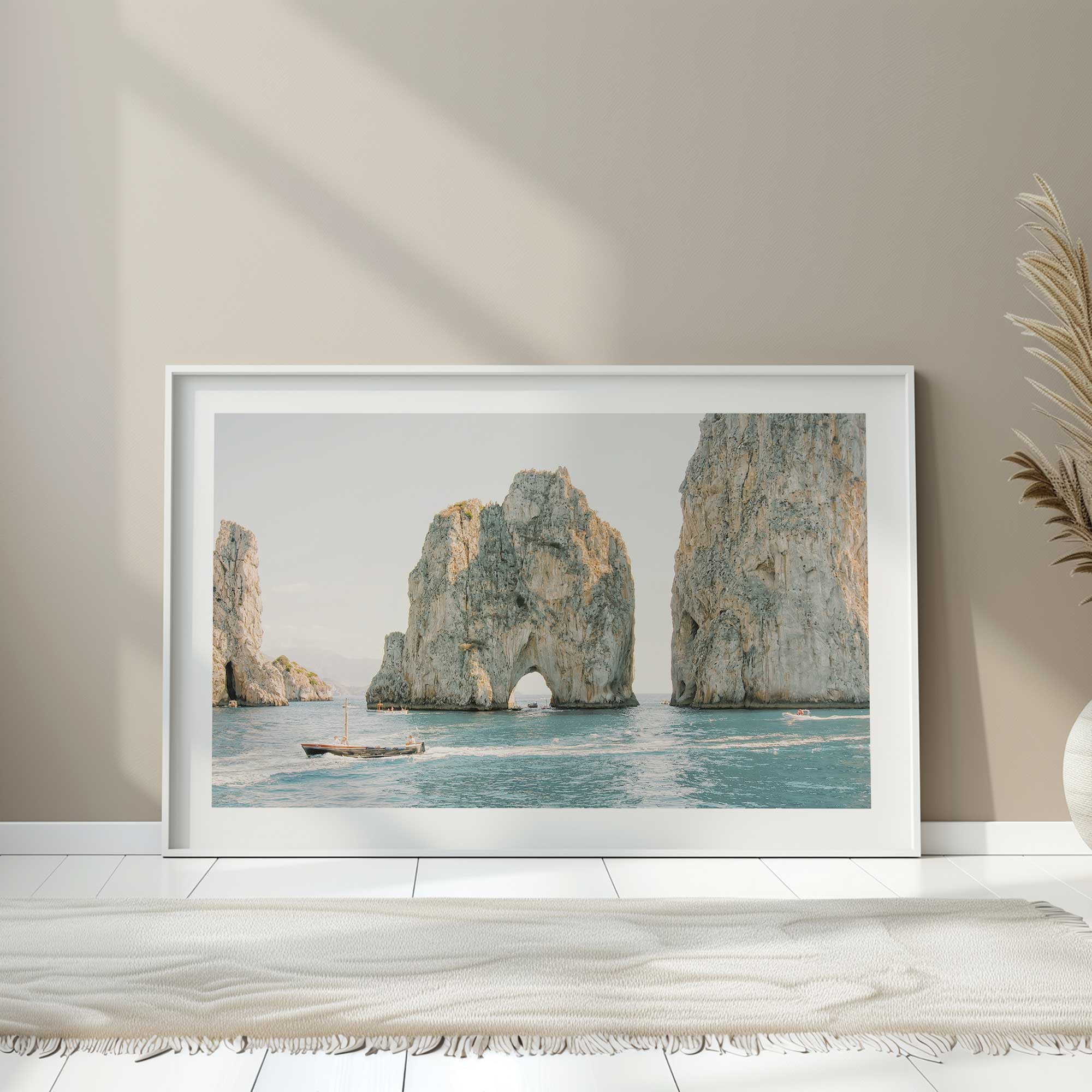 ocean arches print in a white frame on a floor