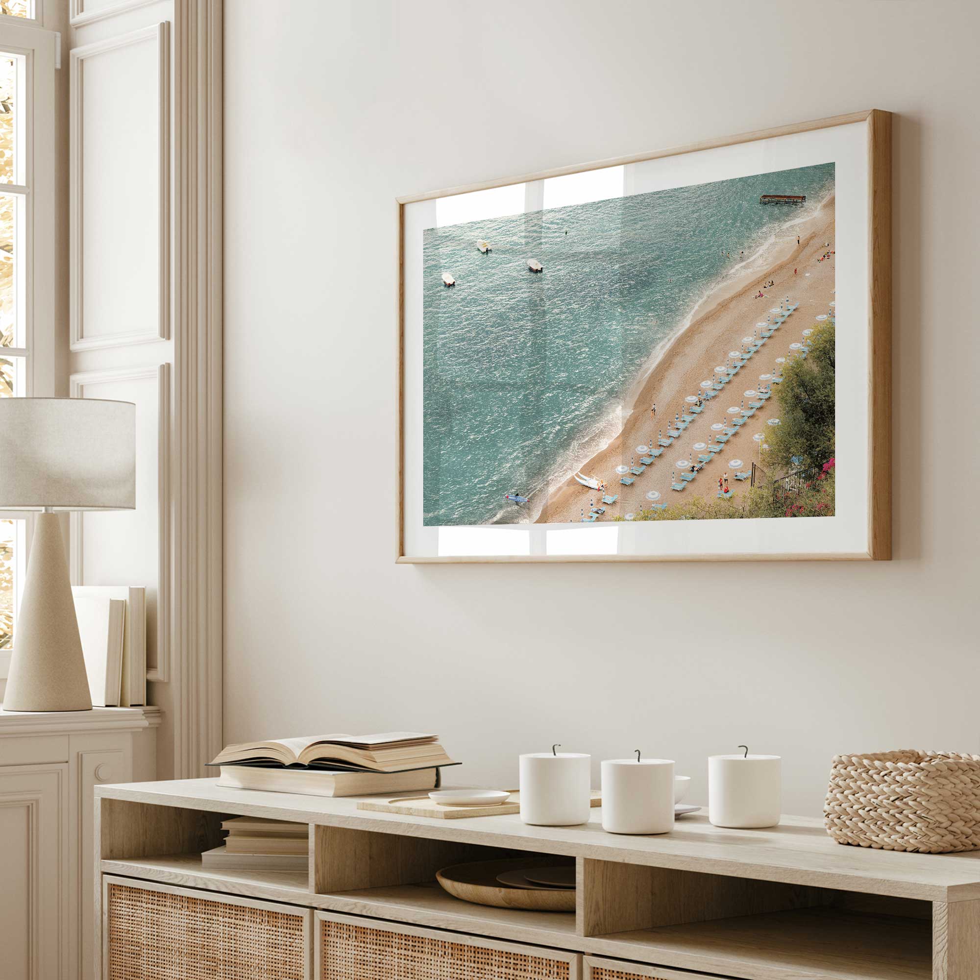 summer escape print in a natural wood frame on a living room wall