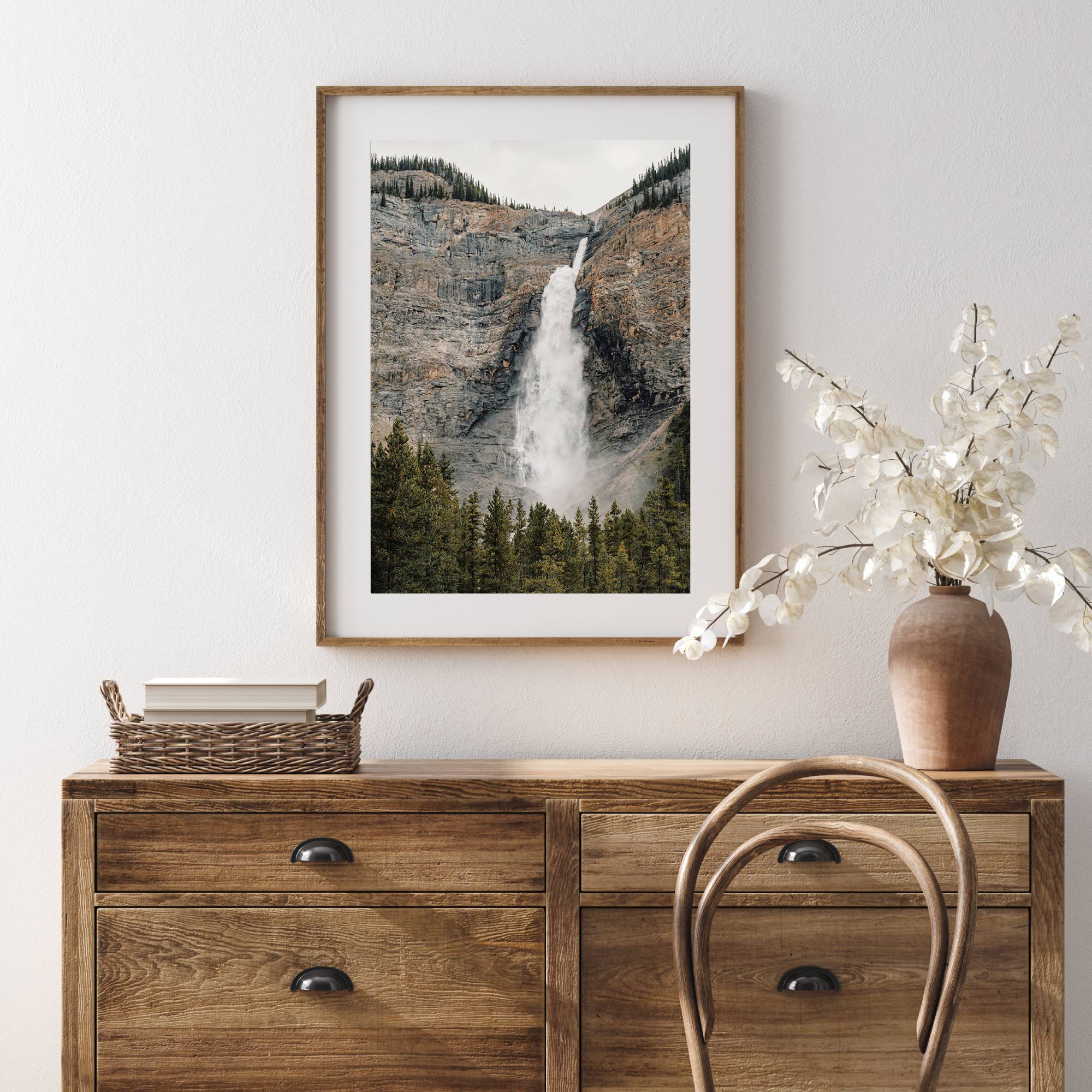 mountain cascade print in a wooden frame hung on a wall